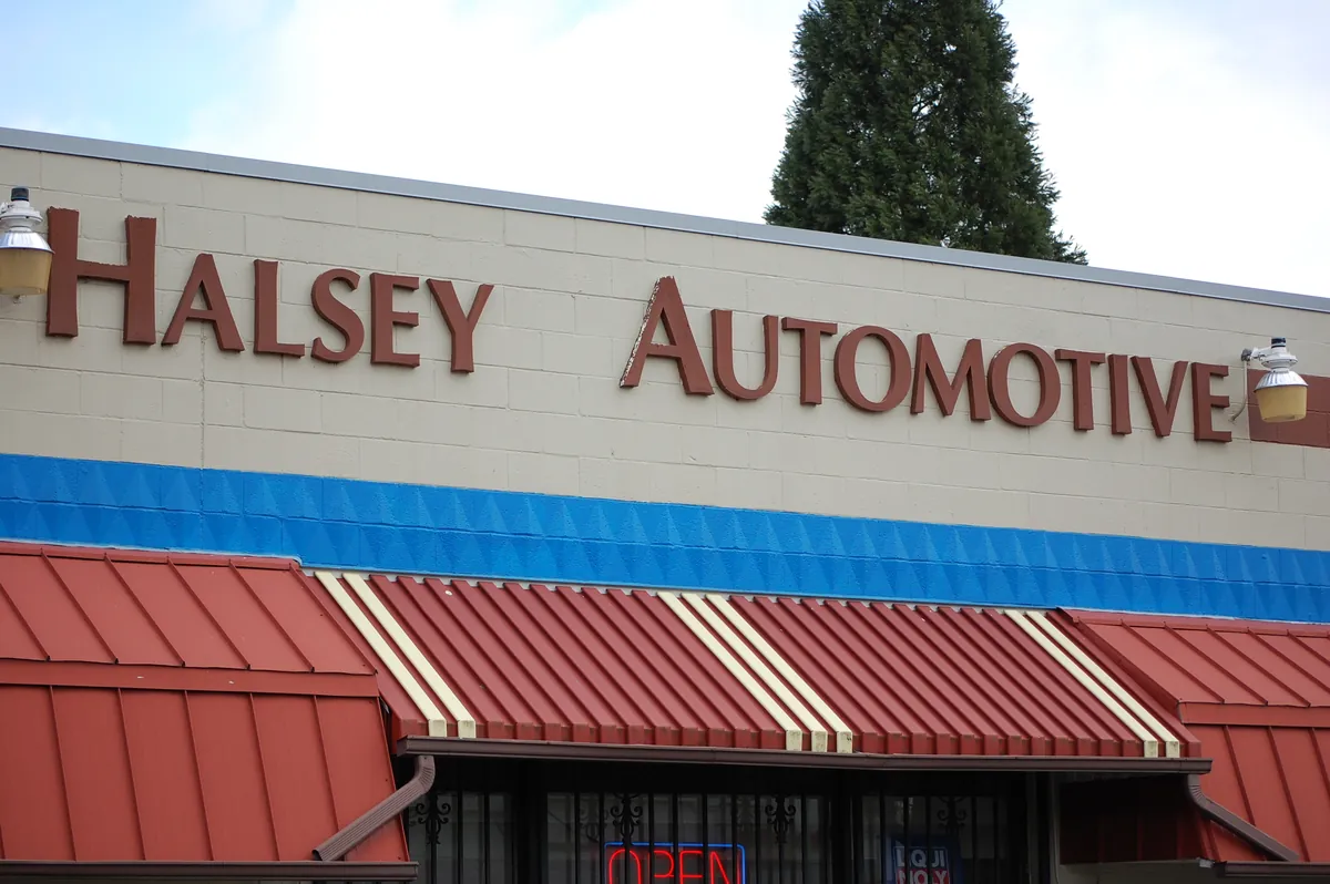 Halsey Import Parts storefront on NE Halsey Street, with the original Halsey Automotive building lettering and red awnings