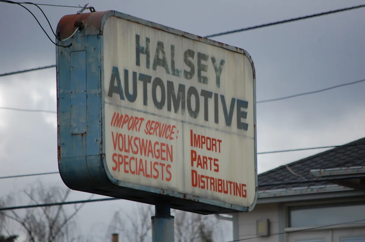 Vintage Halsey Automotive sign on NE Halsey Street reading Import Service, Volkswagen Specialists, Import Parts Distributing