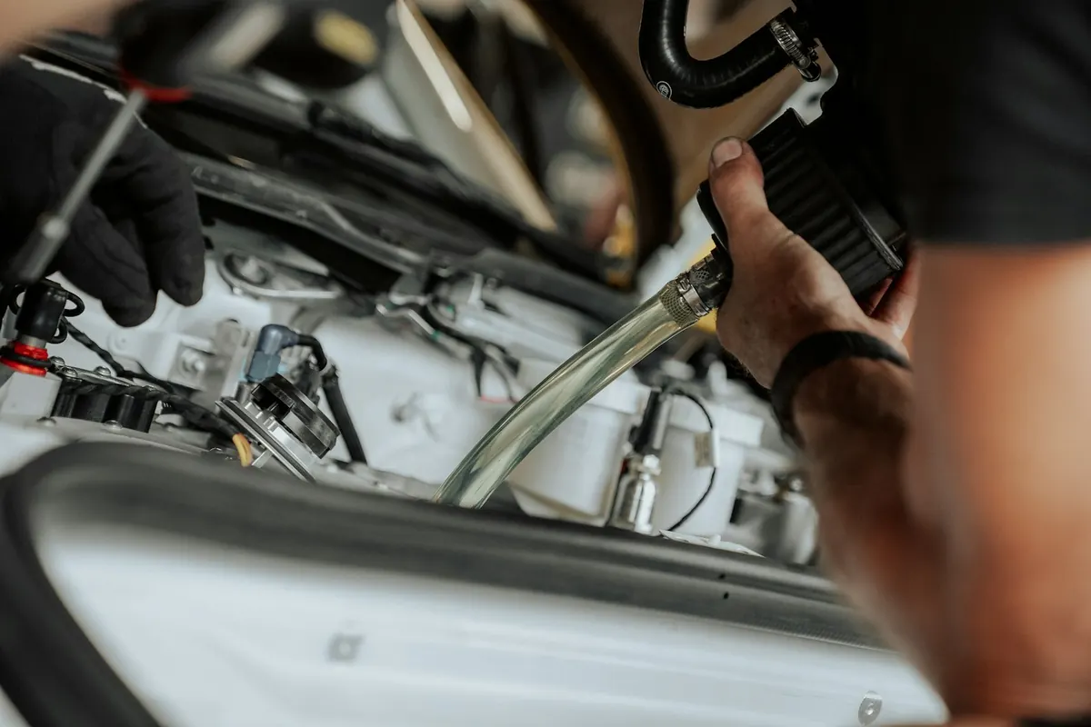 Mechanic working on engine components in a car’s engine bay